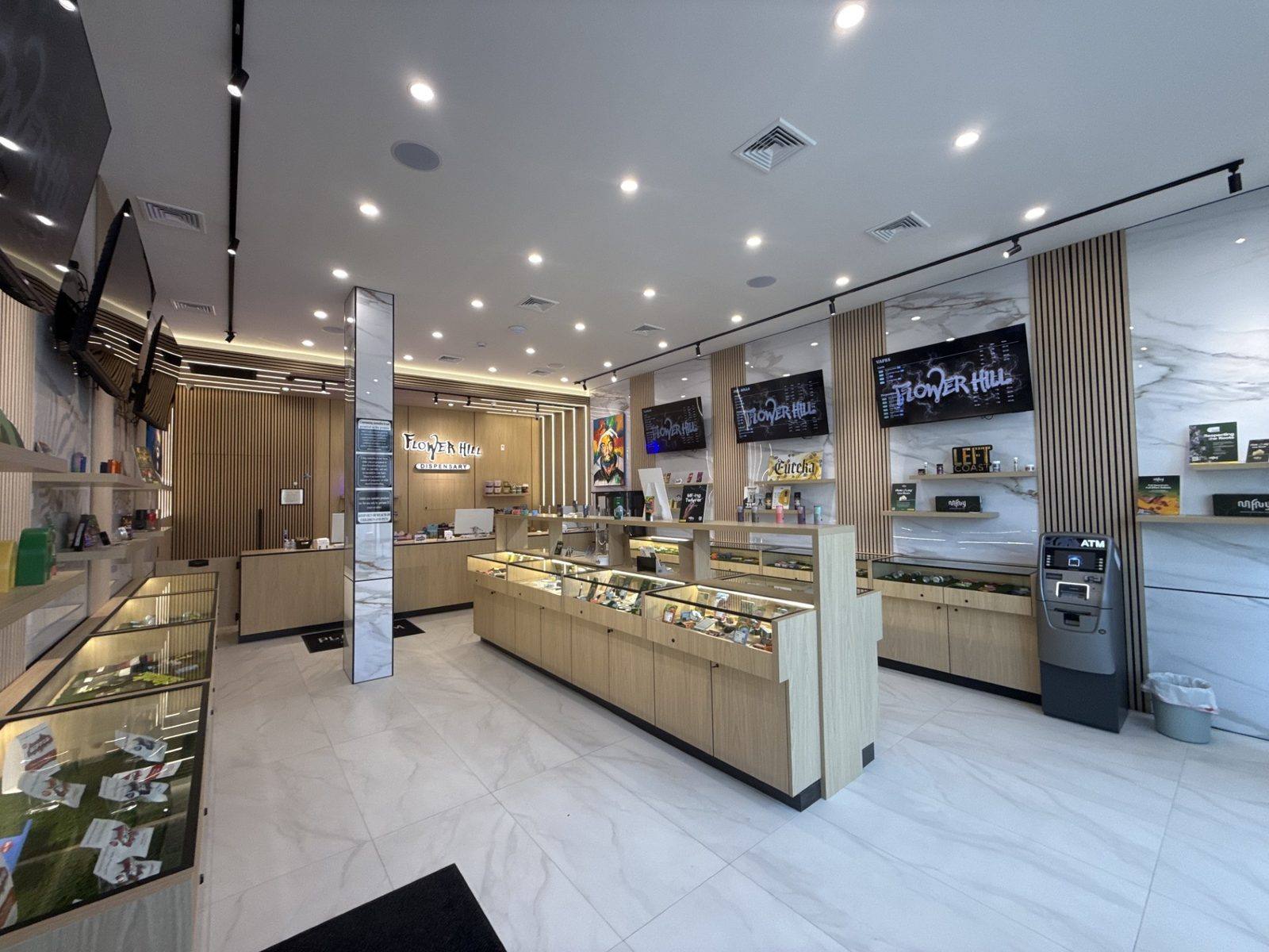Flower Hill Dispensary interior with digital menu boards and ATM